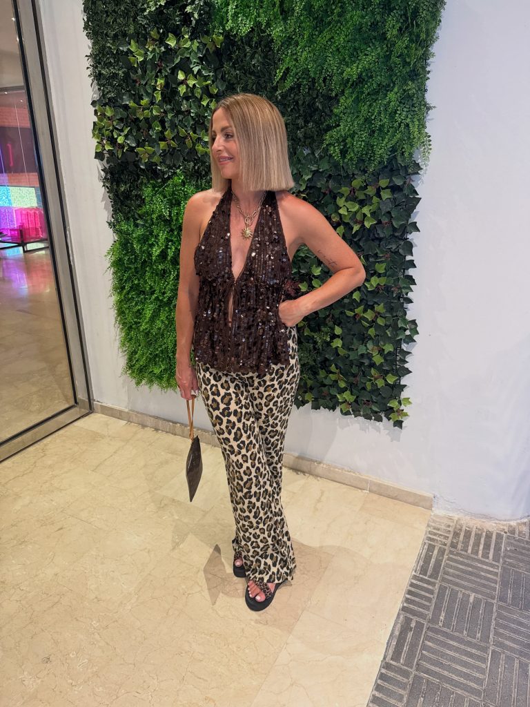 A Sequined Brown Top with Leopard Pants for Evening Confidence